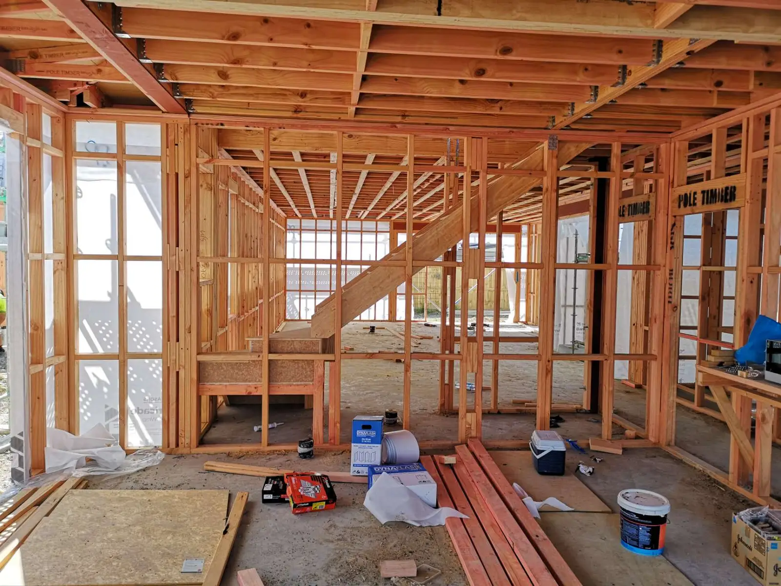 Timber-framed ground floor with the staircase stringers in place