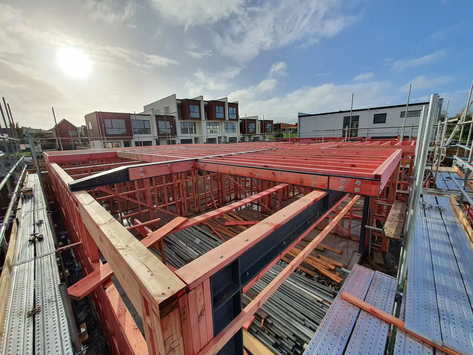 First-floor joists bolted to steel beams on a timber-framed home